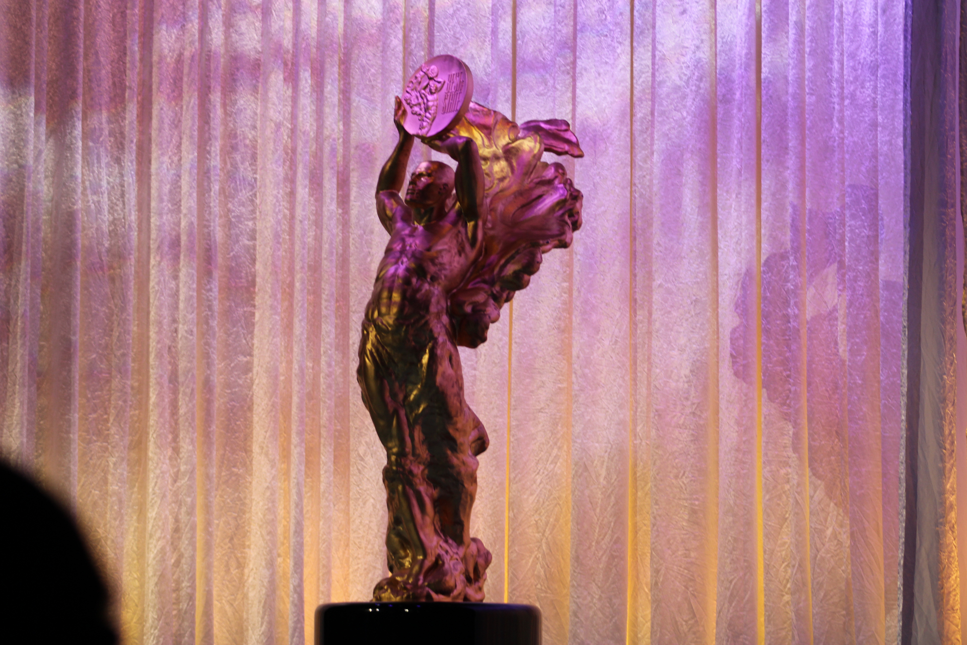 The Best of State Statue — the BOSS® — under stage light.